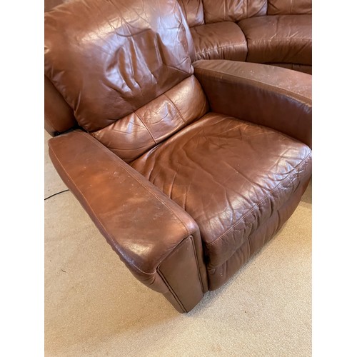 234 - A large brown leather curved sofa together with electric reclining armchair