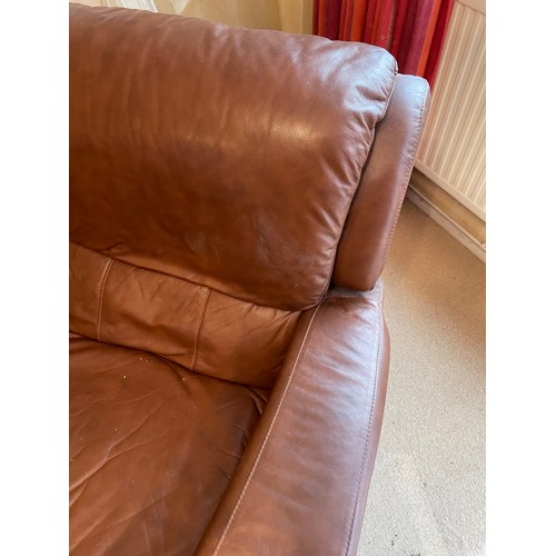 234 - A large brown leather curved sofa together with electric reclining armchair