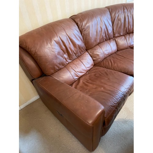 234 - A large brown leather curved sofa together with electric reclining armchair