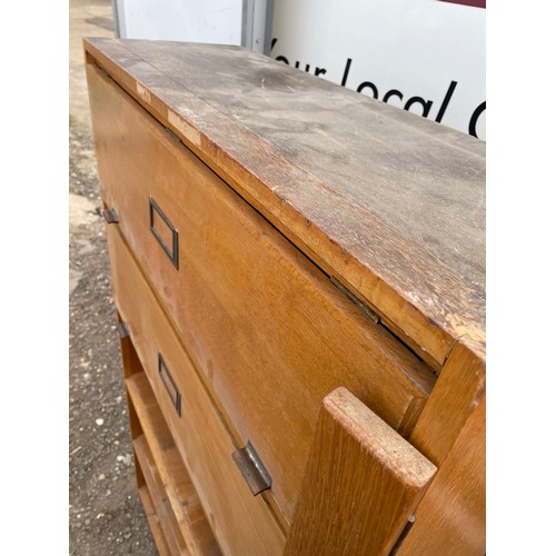 421 - An oak pigeon hole office cabinet with two up and over doors