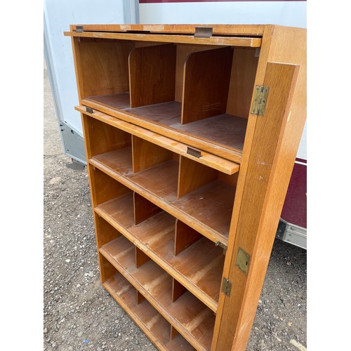 421 - An oak pigeon hole office cabinet with two up and over doors