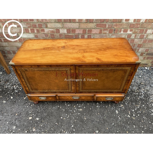 106 - A yew wood military style mule chest with two cupboard doors over three drawers