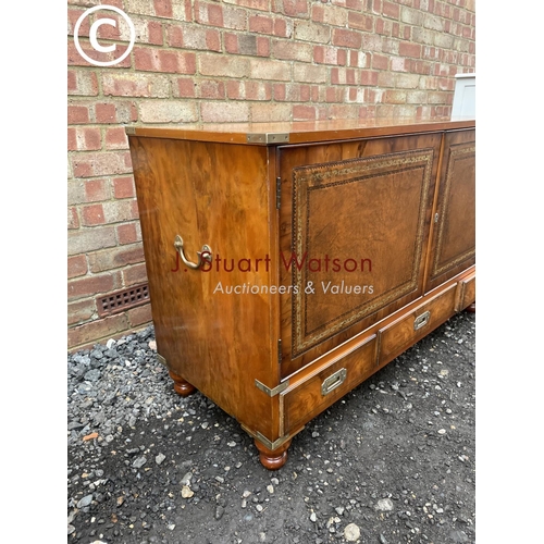 106 - A yew wood military style mule chest with two cupboard doors over three drawers