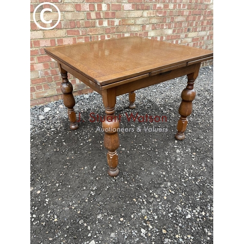 111 - An oak drawer leaf dining table