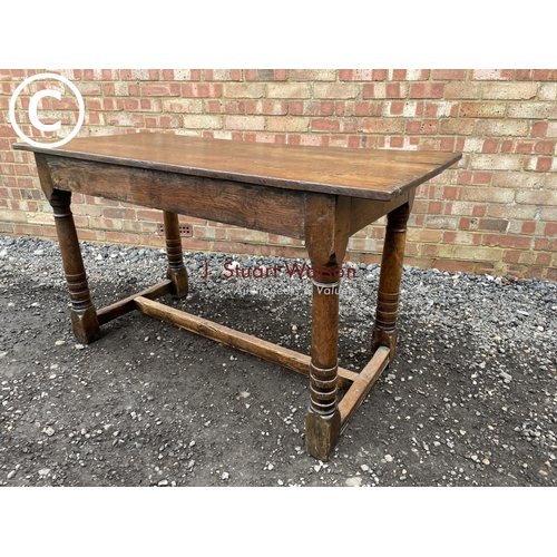 114 - An oak stretcher table with a single central drawer 138x60x77