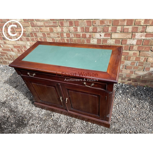 13 - An indonesian style hardwood sideboard with a green leather top