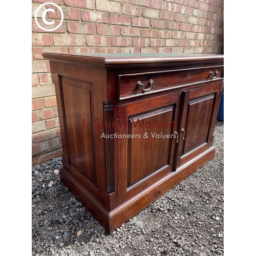 13 - An indonesian style hardwood sideboard with a green leather top