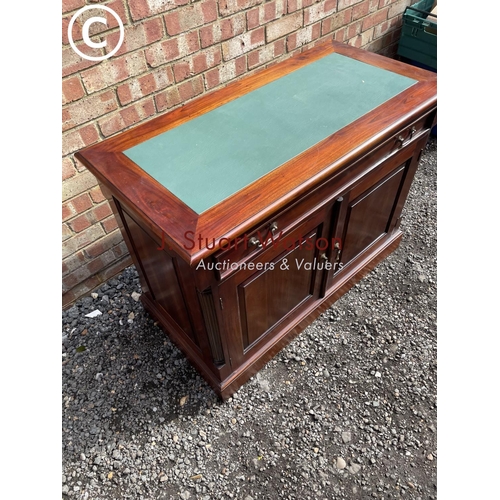 13 - An indonesian style hardwood sideboard with a green leather top