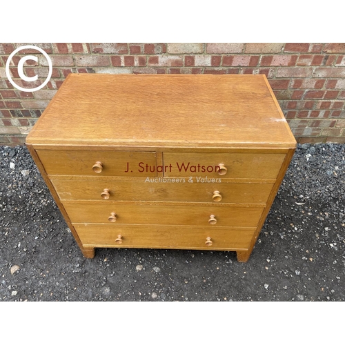 135 - A mid century light oak chest of five drawers