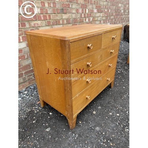 135 - A mid century light oak chest of five drawers