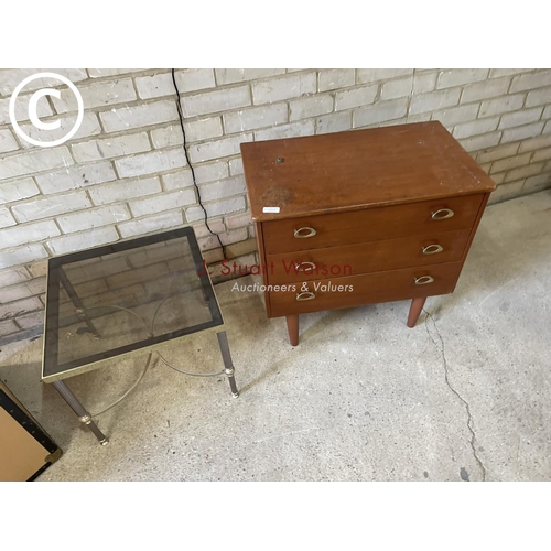 148 - A teak chest of three together with a brass and glass side table