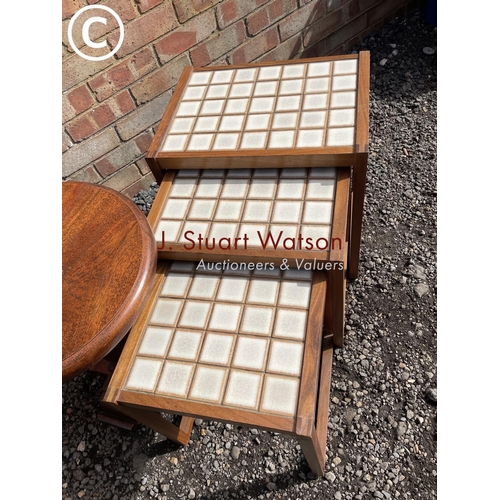 15 - A tile top teak nest of three together with a wine table