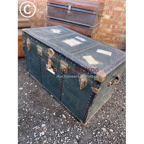 153 - Four vintage tin trunks together with a large green trunk