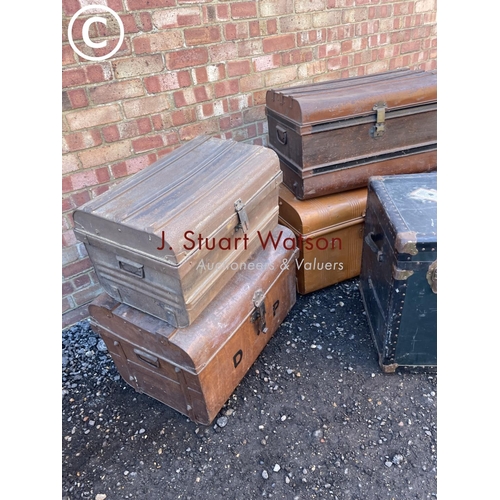 153 - Four vintage tin trunks together with a large green trunk