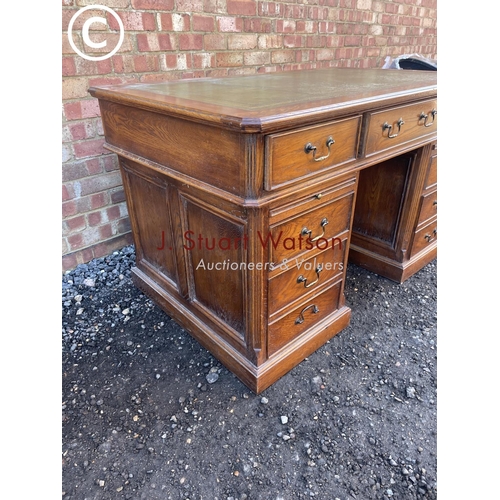 160 - An american style modern oak twin pedestal desk with green leather top