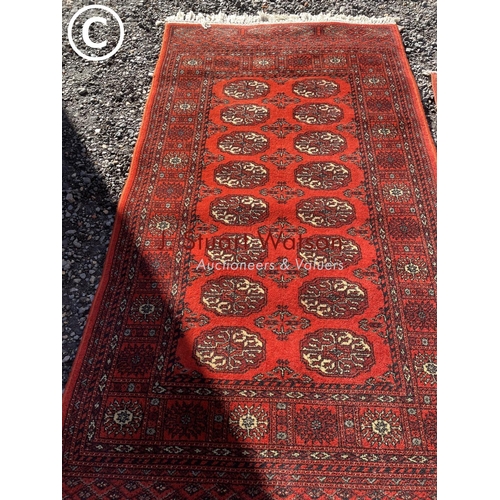 166 - Three red oriental pattern rugs 155x95