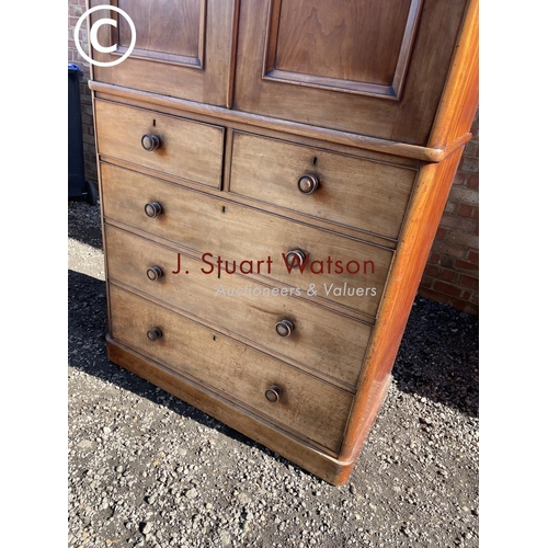 191 - A large Victorian mahogany linen press fitted with slides  to the top over a five drawer base 110x55... 