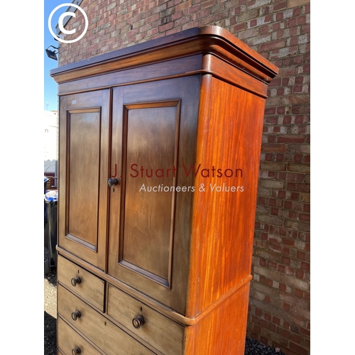 191 - A large Victorian mahogany linen press fitted with slides  to the top over a five drawer base 110x55... 