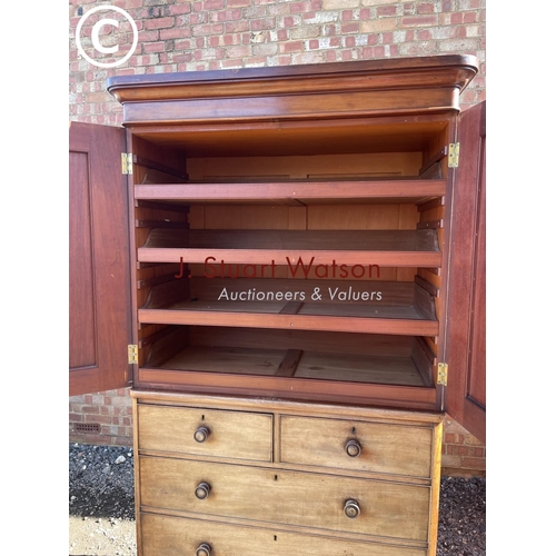 191 - A large Victorian mahogany linen press fitted with slides  to the top over a five drawer base 110x55... 