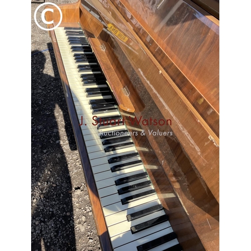 192 - A walnut cased upright piano 135 wide