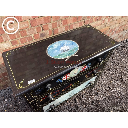 22 - A black painted chest of three drawers decorated with ship scenes