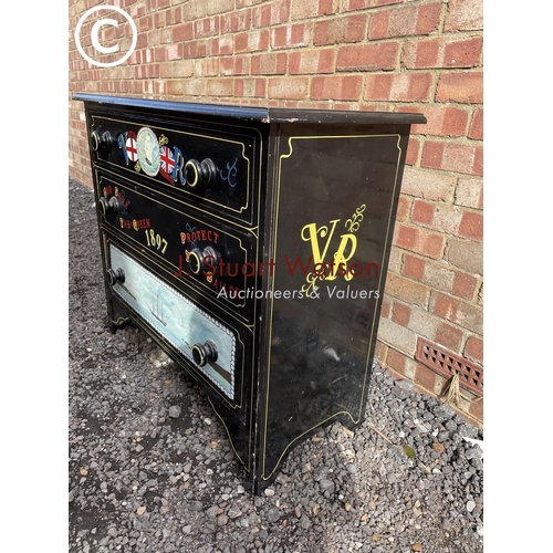 22 - A black painted chest of three drawers decorated with ship scenes