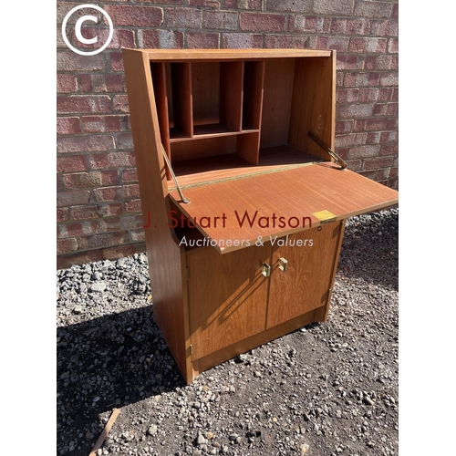 221 - A compact mid century teak bureau