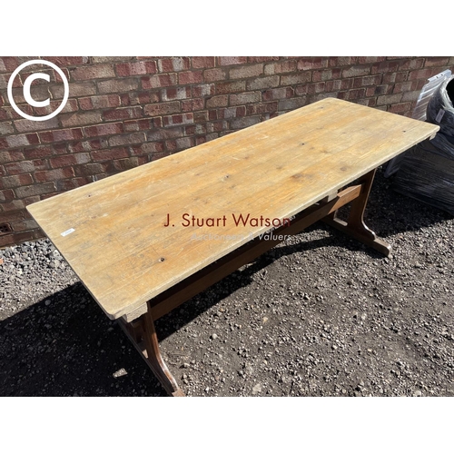 222 - An oak based twin stretcher refectory style table with pine top 183x66x70