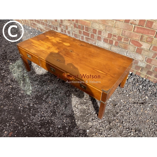 24 - A reproduction military style yew wood coffee table with three drawers and three dummy drawers