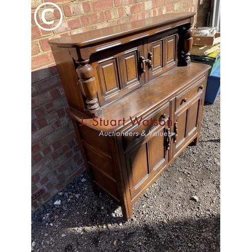 252 - A dark ercol court cupboard