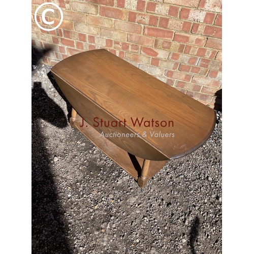 253 - An ercol dark elm drop leaf coffee table