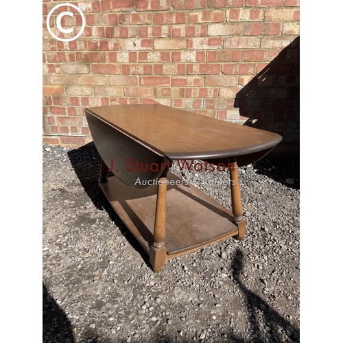 253 - An ercol dark elm drop leaf coffee table