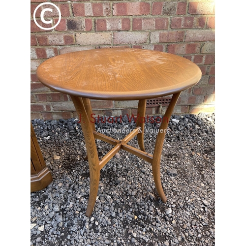 255 - An ercol corner cabinet together with a ercol side table