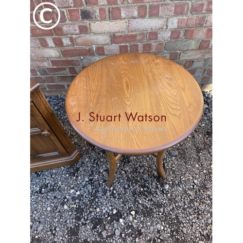 255 - An ercol corner cabinet together with a ercol side table