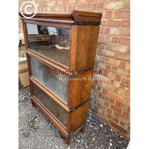 270 - A globe wernicke three section stackimg bookcase with up and over glazed doors 86x30x125