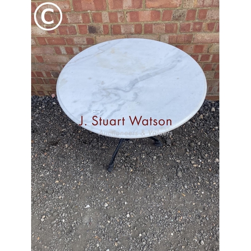 288 - A circular iron based bistro style table with white marble top