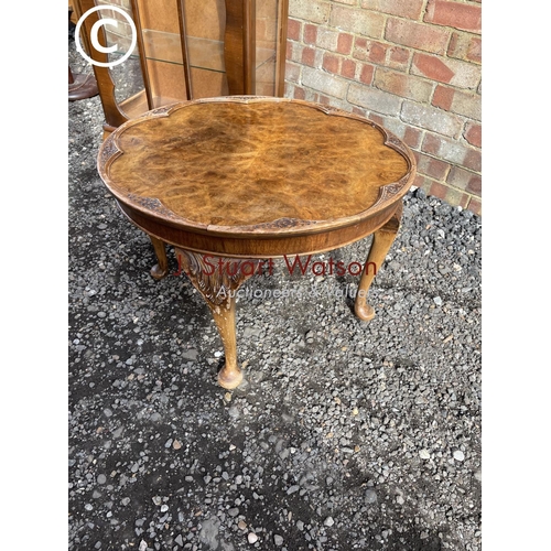 29 - A walnut china cabinet with three glass shelves together with a walnut coffee table