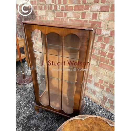 29 - A walnut china cabinet with three glass shelves together with a walnut coffee table