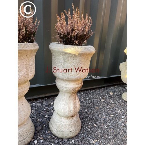 344 - A pair of circular column form planters with plant 60 high