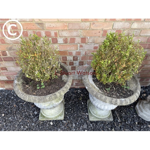 354 - A pair of good quality weathered concrete urn planters both decorated with cherub scenes 60high 50 d... 