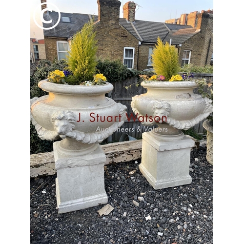 361 - A pair of impressively large painted concrete urn planters, each decorated with four lion heads and ... 