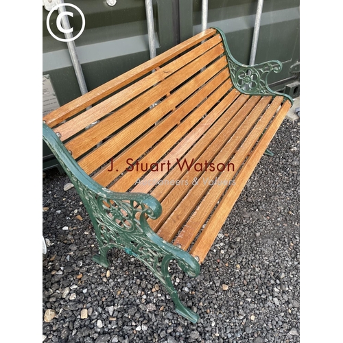 365 - A refurbished garden bench with green painted ironwork frame and slatted seat 126wide