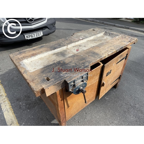 39 - A large vintage carpenters workshop bench fitted with vice and cupboard to each side 153x77x84