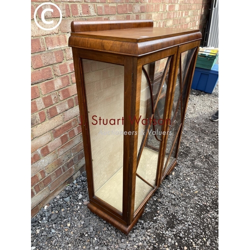 48 - A 1920's walnut display cabinet with three internal shelves