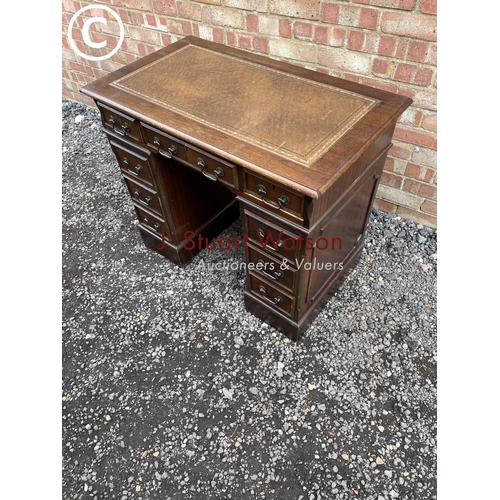 50 - A small reproduction mahogany twin pedestal desk with brown leather top