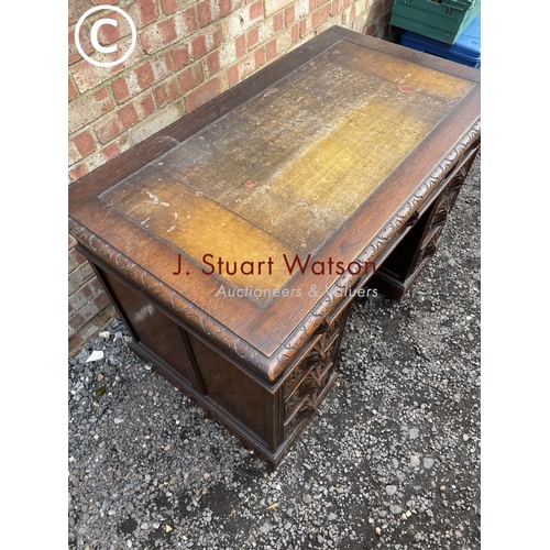 50 - A small reproduction mahogany twin pedestal desk with brown leather top