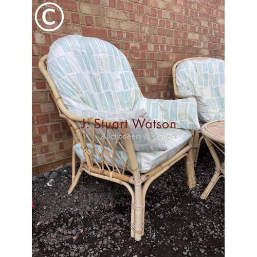 64 - A bamboo three piece conservatory set consisting of two chairs and table