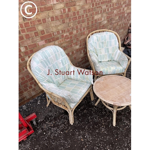 64 - A bamboo three piece conservatory set consisting of two chairs and table