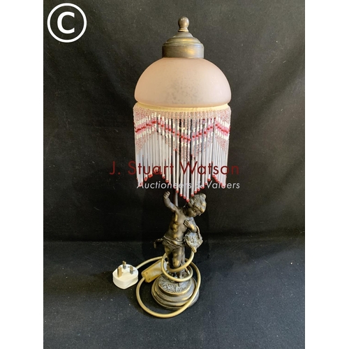 653 - Cherub lamp with beaded shade, height 48cms