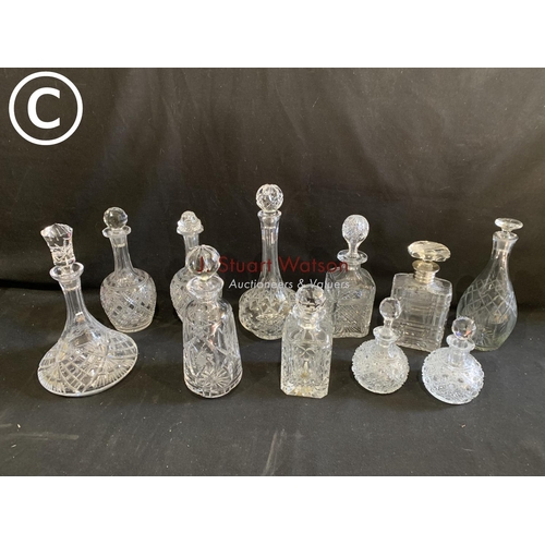 660 - Collection of 11 cut glass decanters